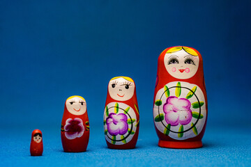 unfolded matryoshka dolls on a blue background