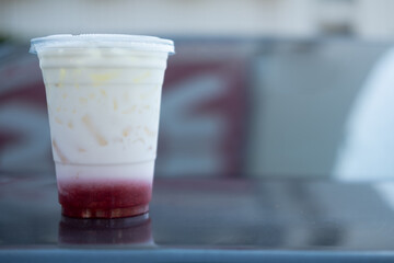 Fresh milk with delicious strawberry in plastic cup