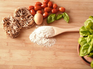 Pasta, flour, egg, basil and tomatoes
