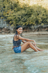 Amazing Portrait of a Beautiful and Cheerful Filipino Asian Teenager Posing on an Exotic Island White Sand Beach in Siargao, Philippines.