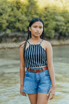 Amazing Portrait of a Beautiful and Cheerful Filipino Asian Teenager Posing on an Exotic Island White Sand Beach in Siargao, Philippines.