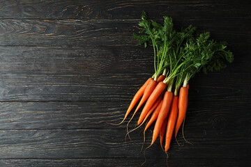 Heap of fresh carrot on wooden background