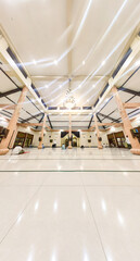 Serang, Indonesia : a beautiful interior architecture of a mosque with high pillars and lights. There are people who are worshiping