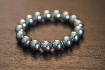 Shallow depth of field metal balls on wood textured brown background.