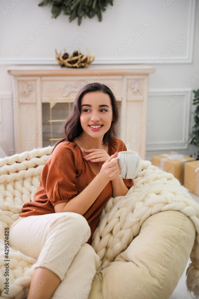 Sticker Woman with hot drink resting in comfortable papasan chair at home