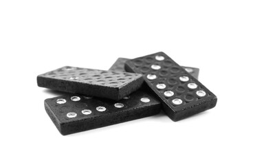 Pile of black domino tiles on white background