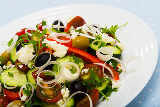 Image of Shopska salad in plate on the table indoor.