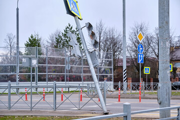 Falling traffic light at a pedestrian crossing. Security threat. Negligence of road services