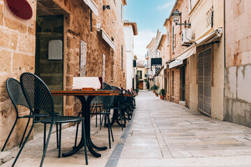 Fototapeta na wymiar Empty tables of street cafe, Spain