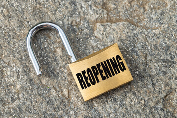 Open padlock placed on a rock surface, with 