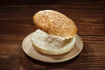 Burger bun on wooden background