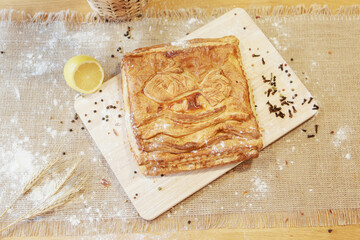 Pie, lime and pepper on a chopping board. The food is ready to eat. Puff Pastry pastry