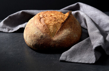 food, baking and cooking concept - homemade craft bread on table