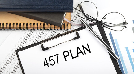 Text 457 PLAN on Office desk table with notebooks, supplies,analysis chart, on white background. Top view