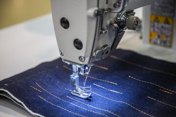 needle in a sewing machine in an atelier or a weaving factory.