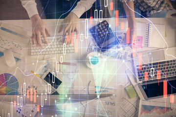 Double exposure of man and woman working together and financial chart hologram drawing. market analysis concept. Computer background. Top View.