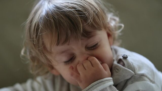 Toddler boy nose picking. Child picks his nose