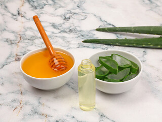 Aloe Vera and honey closeup on light marble background