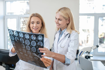 Two happy doctors discussing MRT scan