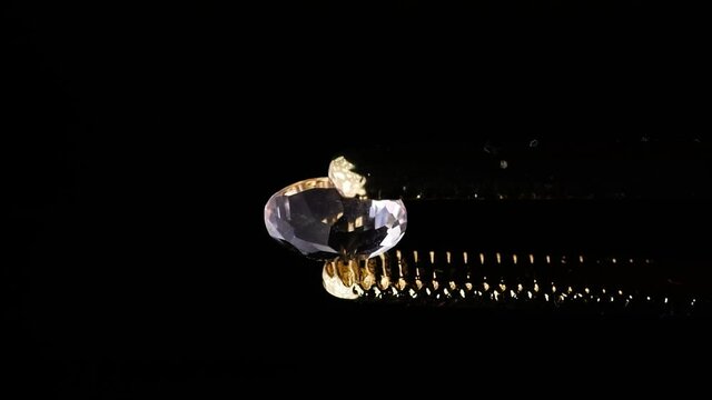 natural morganite gemstone in tweezer on the turn table