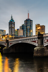 Princes Bridge and city buildings on the Yarra River in Melbourne, Australia in the evening - 2021