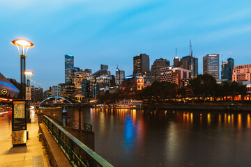 Fototapeta na wymiar Melbourne, Australia - April 8, 2021: Yarra river and city buildings in evening