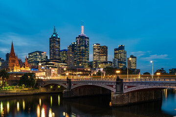 Fototapeta na wymiar Princes Bridge and city buildings on the Yarra River in Melbourne, Australia in the evening - 2021