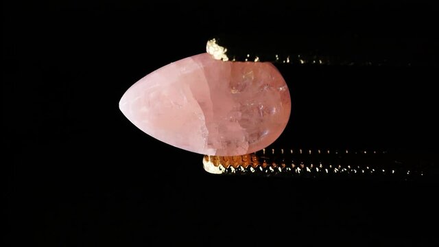 natural morganite gemstone in tweezer on the turn table