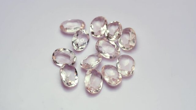 natural morganite gemstone on the white background on the turning table