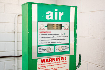 Air station service for vehicle tires. Automatic inflator with pressure level indicator on 33 psi...