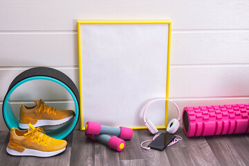 yellow sneakers, massage rollers and dumbbells, note board, headphones and honeycomb