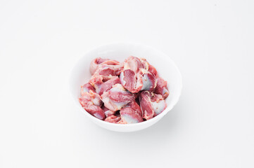 Raw chicken thighs on a white plate on a white background. Mockup