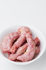 raw chicken necks on a white plate isolated on a white background. Mockup