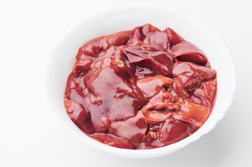 raw chicken liver in a white plate on a white background. Mockup 