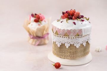 Obraz na płótnie Canvas two Easter cakes on a pink background decorated with dried flowers