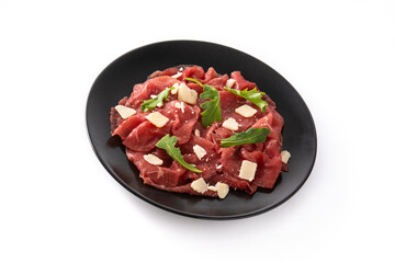 Marbled beef carpaccio on black plate isolated on white background