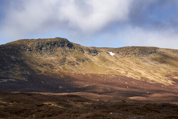 Fototapeta na wymiar The rocky mountain outcrop of Cam Chreag in the winter Scottish Highlands, UK Landscapes.