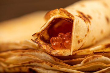 Traditional Russian pancakes with red salmon caviar. Shrovetide week of the meeting of spring.