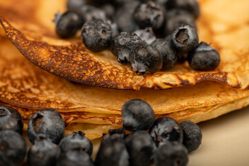 Fresh blueberries and traditional Russian pancakes. Shrovetide week of the end of winter.