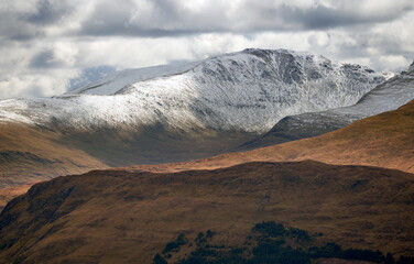 Fototapeta na wymiar The snow covered ridge and summit of Meall Garbh in the winter Scottish Highlands, UK Landscapes.