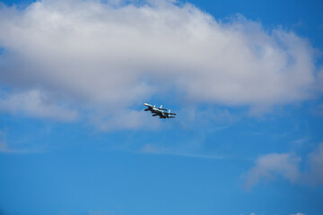 four jet planes are flying in a tight formation. dangerous aerobatics are shown at the aviation festival by pilots. military parade of modern fighter planes