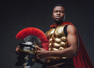 Antique roman soldier holding helmet
