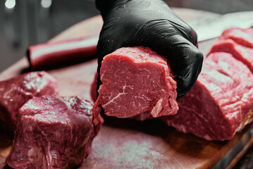 sliced raw beef tenderloin. fresh raw beef tenderloin on a wooden cutting board. 