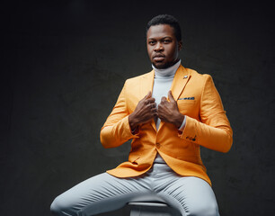 Trendy african guy with orange coat