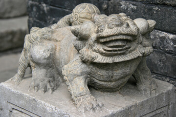 statue of a lion (?) in an ancient house in pingyao (china)