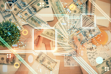 Multi exposure of technology drawing hologram and us dollars bills and man hands. Data concept