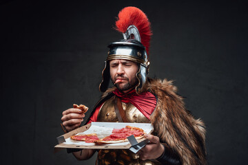 Unhappy soldier of ancient rome with pizza