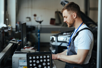 Car mechanic installing sensor  adjustment and automobile wheel