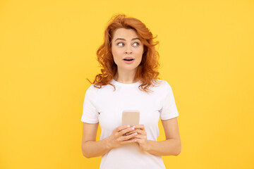 surprised redhead woman chatting in smartphone or make online shopping, communication.