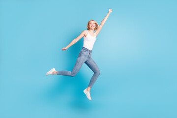 Fototapeta na wymiar Full length body size view of attractive cheerful girl jumping striving having fun isolated over bright blue color background